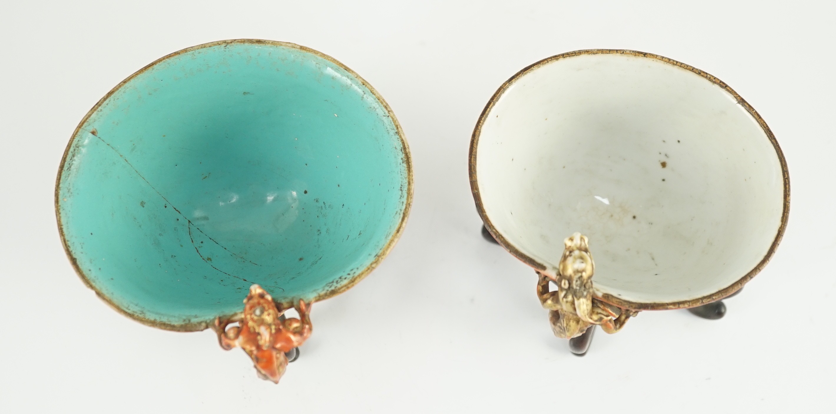 Two similar Chinese coral ground libation cups, late 18th/early 19th century, 10.5cm and 11.5cm across, wood stands